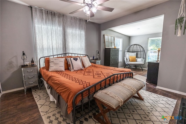 bedroom with ceiling fan and dark wood-type flooring