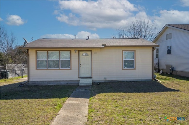 bungalow featuring fence, a front lawn, and entry steps