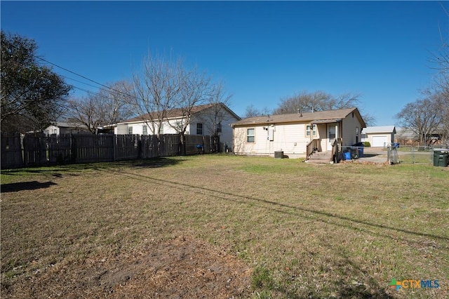 view of yard with a garage and fence