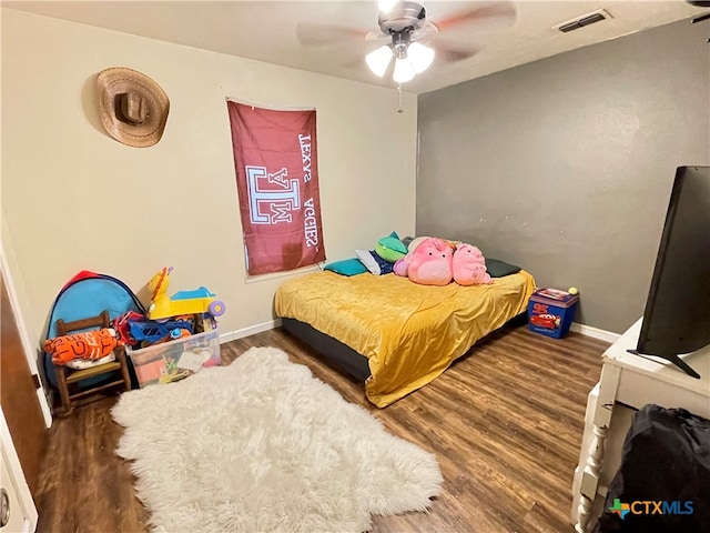 bedroom featuring ceiling fan and dark hardwood / wood-style floors