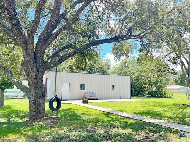 view of outdoor structure featuring a lawn