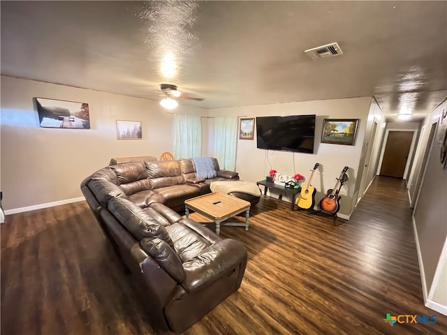 living room with dark wood-type flooring and ceiling fan