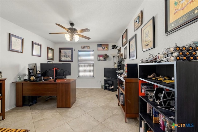 office featuring light tile patterned floors, a ceiling fan, and baseboards