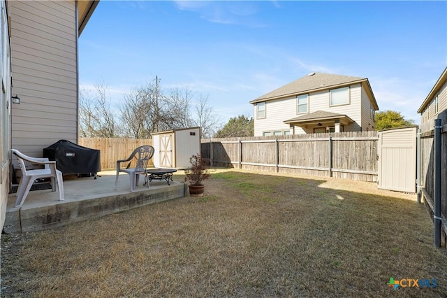 view of yard with a patio, an outbuilding, a fenced backyard, and a shed