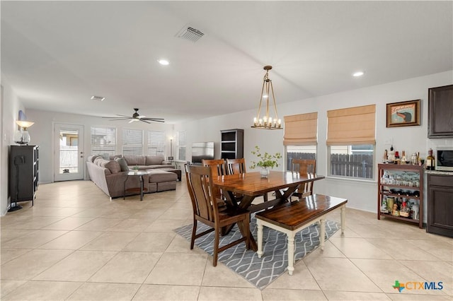 dining space with recessed lighting, visible vents, light tile patterned flooring, and ceiling fan with notable chandelier