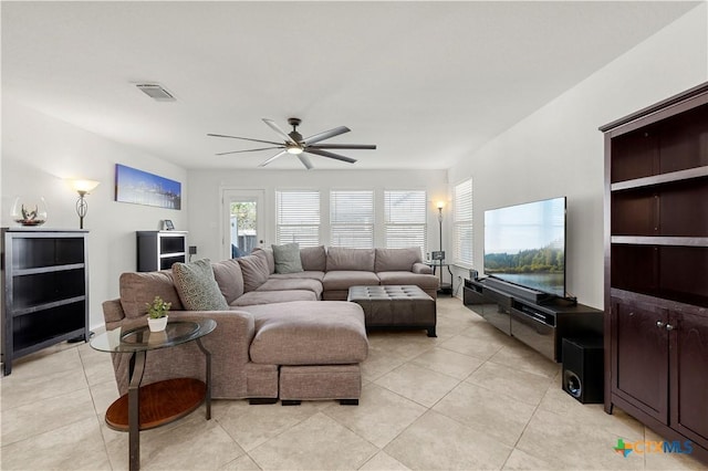 living room with light tile patterned floors, a ceiling fan, and visible vents