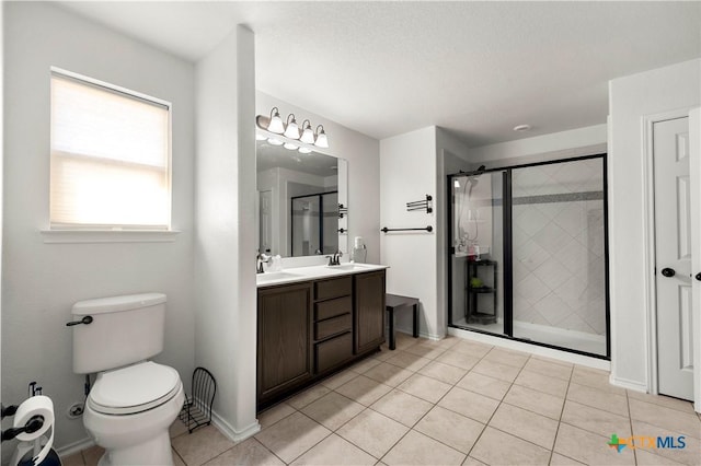 full bathroom with double vanity, a stall shower, toilet, and a sink