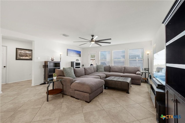 living room with light tile patterned floors, visible vents, and ceiling fan