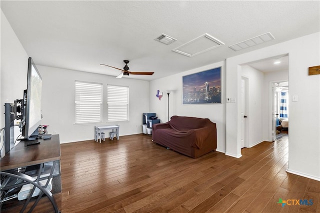 interior space with visible vents, wood-type flooring, attic access, and ceiling fan