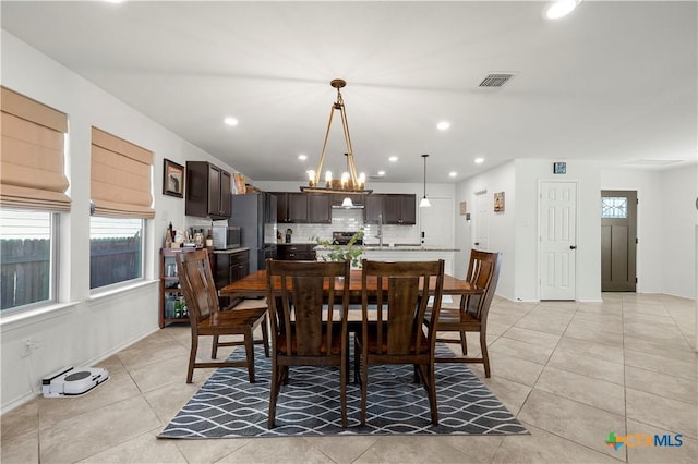 dining area with visible vents, recessed lighting, an inviting chandelier, light tile patterned flooring, and baseboards