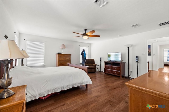 bedroom with visible vents, ceiling fan, and dark wood-style flooring