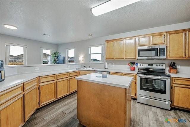 kitchen with visible vents, light countertops, light wood-style floors, and appliances with stainless steel finishes