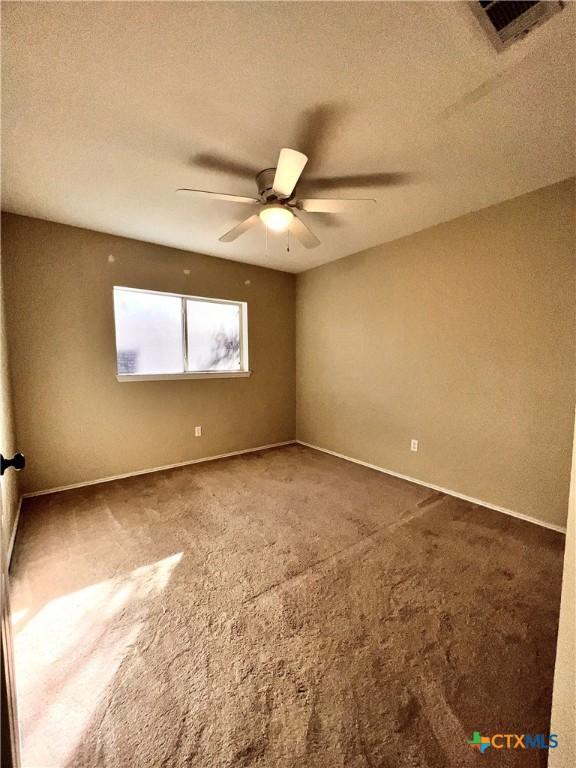 unfurnished living room with dark wood-type flooring, ceiling fan, lofted ceiling, and a brick fireplace