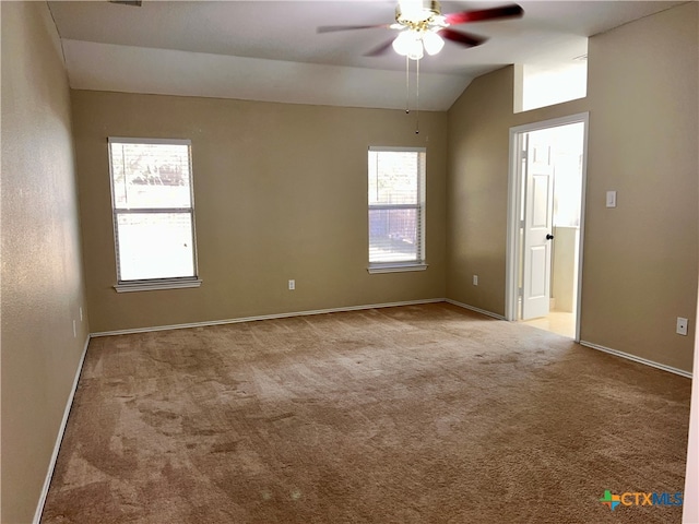 carpeted empty room with ceiling fan and vaulted ceiling