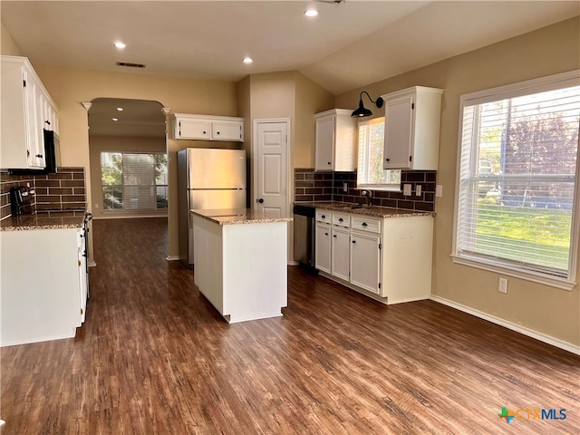 kitchen featuring white cabinets, dark wood-type flooring, and decorative backsplash