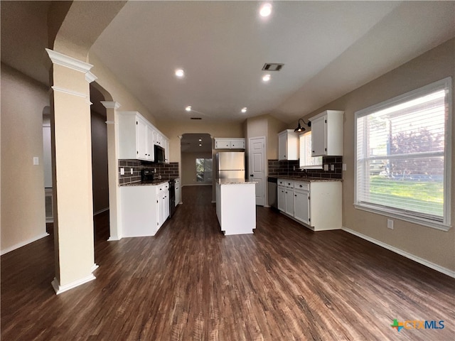 kitchen featuring stainless steel appliances, dark hardwood / wood-style flooring, and decorative backsplash