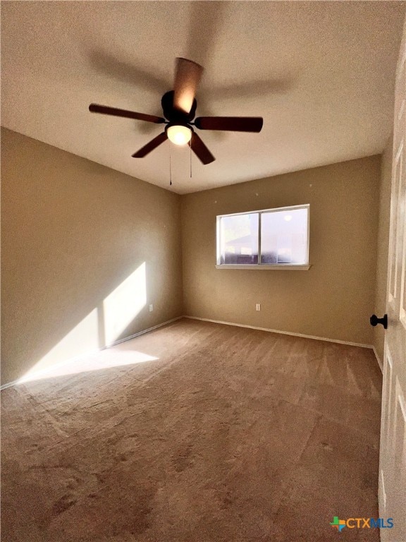 spare room featuring carpet floors, a textured ceiling, and ceiling fan