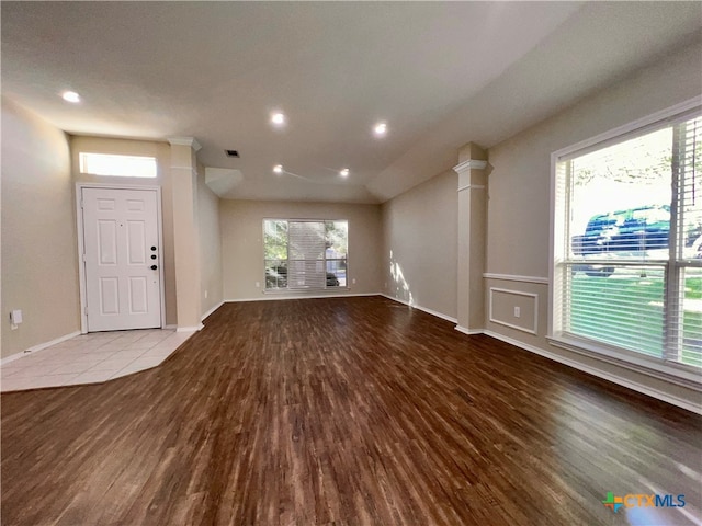 unfurnished living room with light hardwood / wood-style flooring and decorative columns