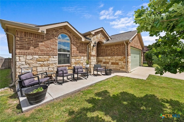 back of house with stone siding, a garage, driveway, and brick siding