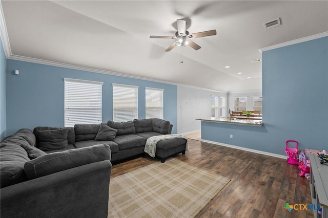 living room with ceiling fan, wood finished floors, ornamental molding, baseboards, and lofted ceiling