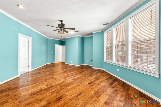 803 S Converse St, Flatonia, TX 78941 - empty room featuring hardwood / wood-style flooring, ceiling fan, a textured ceiling, and ornamental molding