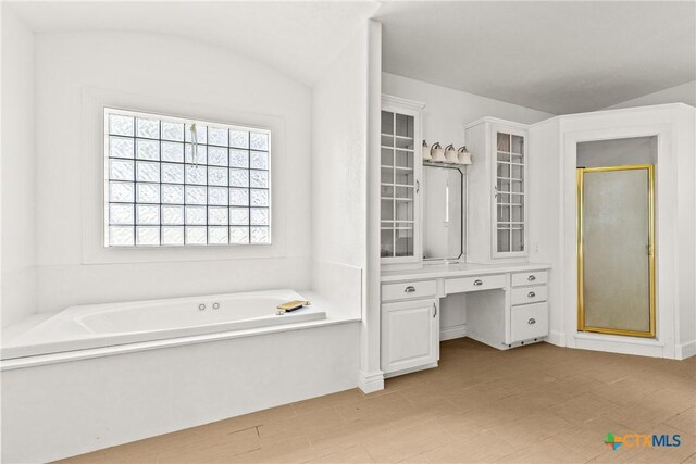 803 S Converse St, Flatonia, TX 78941 - bathroom with a stall shower, a garden tub, and vaulted ceiling