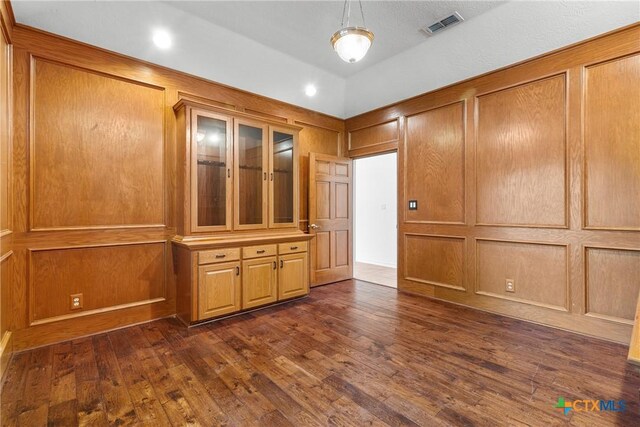803 S Converse St, Flatonia, TX 78941 - unfurnished room with dark wood-style floors and a decorative wall