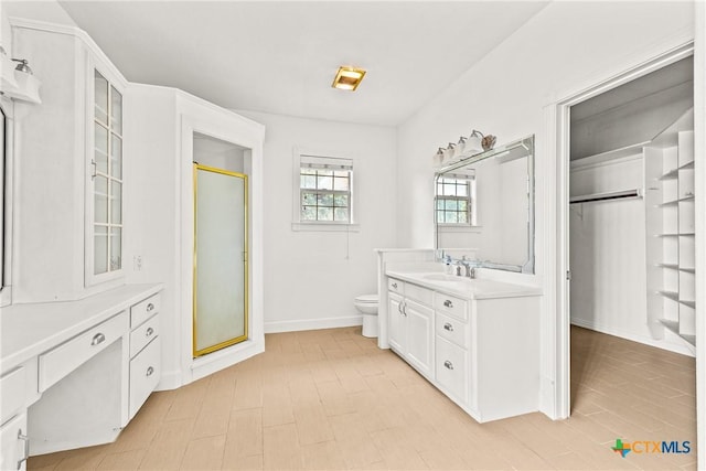 803 S Converse St, Flatonia, TX 78941 - bathroom featuring vanity, a stall shower, and a walk in closet