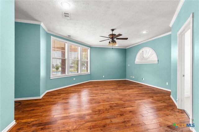 803 S Converse St, Flatonia, TX 78941 - unfurnished room with ceiling fan, a textured ceiling, hardwood / wood-style floors, and ornamental molding