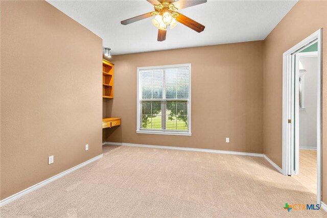 803 S Converse St, Flatonia, TX 78941 - carpeted empty room featuring ceiling fan and an office area