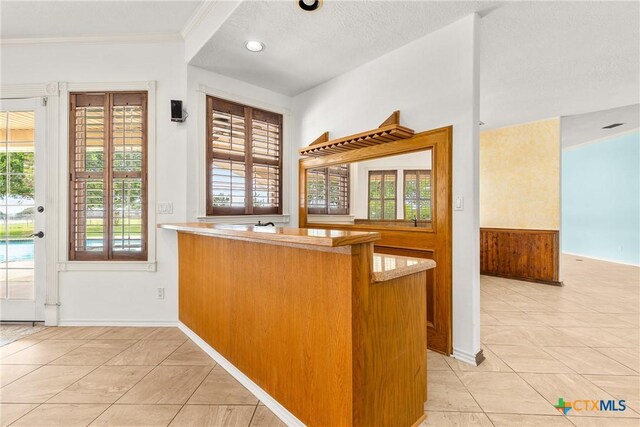 803 S Converse St, Flatonia, TX 78941 - kitchen featuring plenty of natural light, light tile patterned flooring, a peninsula, ornamental molding, and recessed lighting