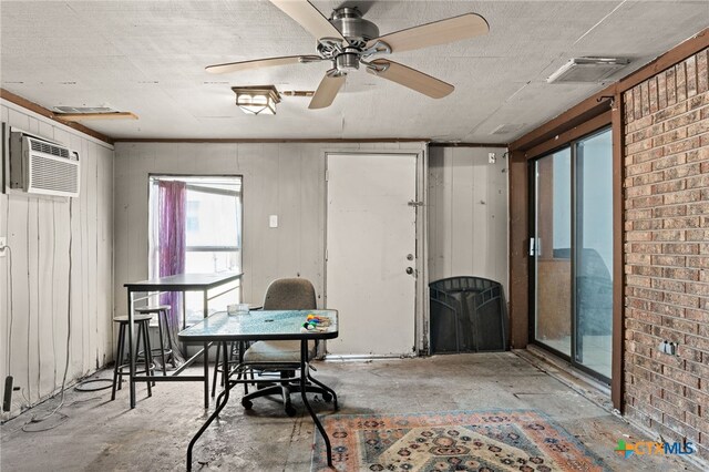 614 Cedar Dr, Copperas Cove, TX 76522 - interior space featuring a wall unit AC, ceiling fan, concrete floors, and brick wall