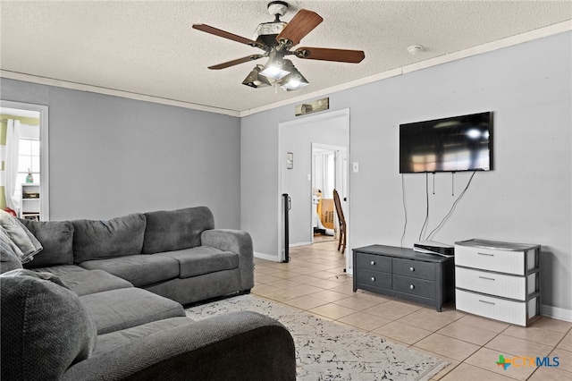 614 Cedar Dr, Copperas Cove, TX 76522 - living area featuring light tile patterned floors, a ceiling fan, a textured ceiling, and baseboards
