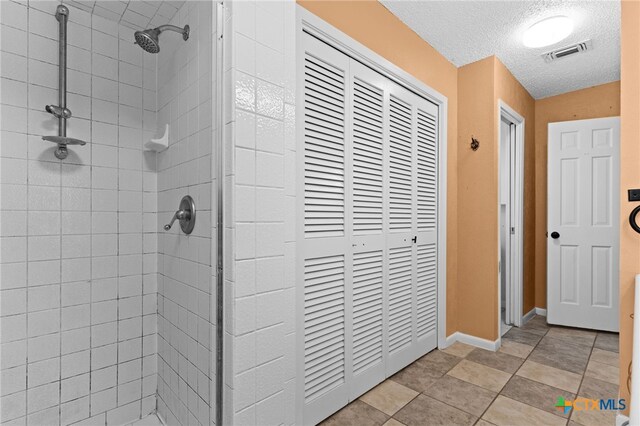 614 Cedar Dr, Copperas Cove, TX 76522 - full bathroom with a shower stall, a textured ceiling, and baseboards