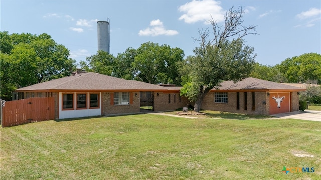 614 Cedar Dr, Copperas Cove, TX 76522 - rear view of property featuring a garage, concrete driveway, brick siding, and a gate