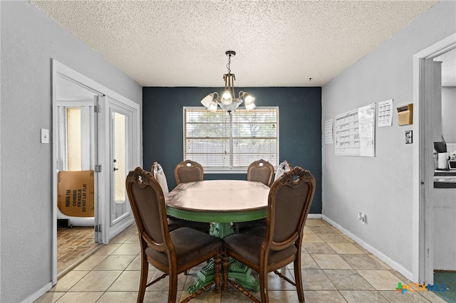 614 Cedar Dr, Copperas Cove, TX 76522 - dining area with a chandelier, a textured ceiling, and light tile patterned floors