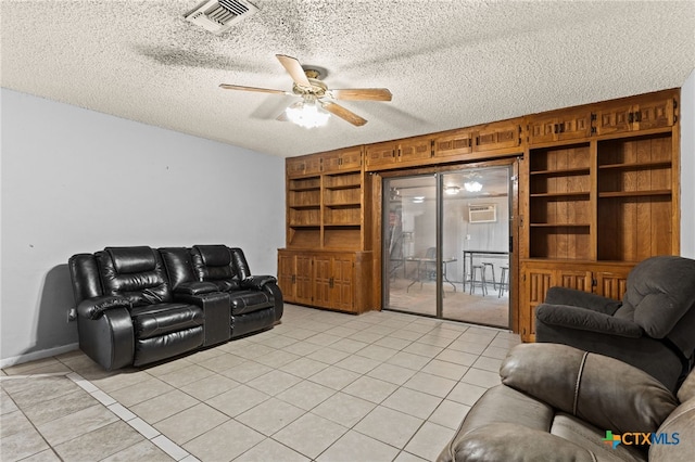 614 Cedar Dr, Copperas Cove, TX 76522 - living room with light tile patterned floors, built in shelves, ceiling fan, and a textured ceiling