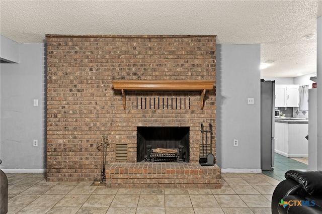 614 Cedar Dr, Copperas Cove, TX 76522 - living area with a textured ceiling, a fireplace, light tile patterned floors, and baseboards