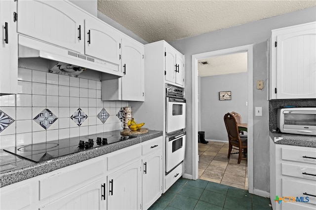 614 Cedar Dr, Copperas Cove, TX 76522 - kitchen featuring under cabinet range hood, black electric stovetop, double oven, white cabinetry, and a textured ceiling