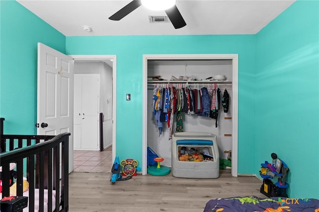 614 Cedar Dr, Copperas Cove, TX 76522 - bedroom featuring a closet, wood finished floors, a ceiling fan, and a crib