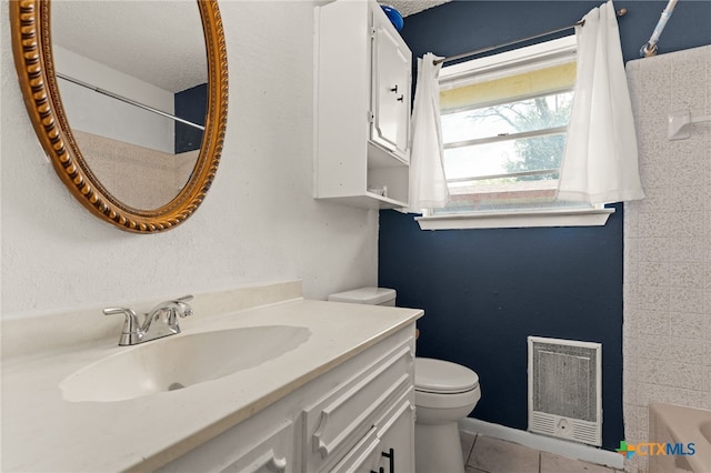 614 Cedar Dr, Copperas Cove, TX 76522 - full bath featuring toilet, heating unit, vanity, tile patterned floors, and shower / bathtub combination