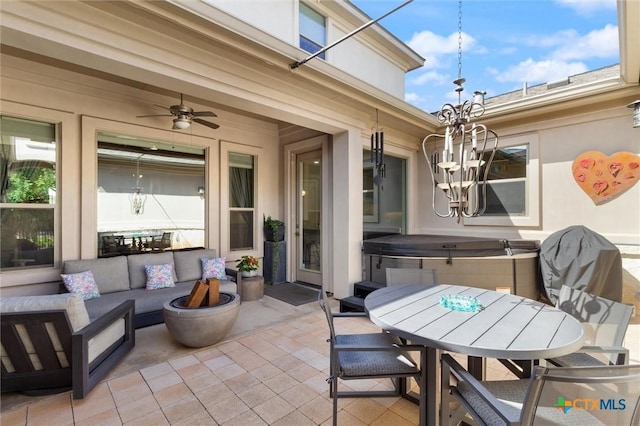 view of patio / terrace with a hot tub, outdoor lounge area, and ceiling fan