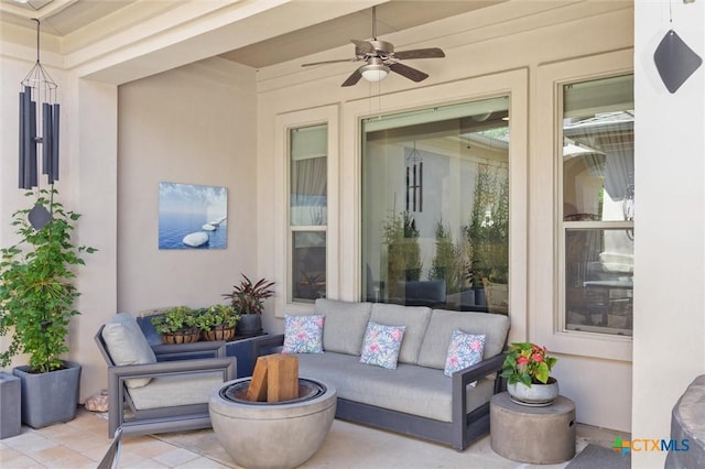 view of patio with an outdoor living space with a fire pit and ceiling fan