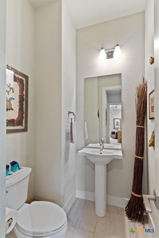 bathroom with tile patterned flooring and toilet