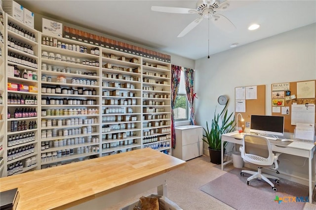 office with light carpet and ceiling fan