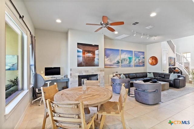 tiled dining room with ceiling fan and a healthy amount of sunlight