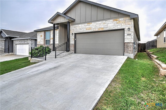 7808 Mcculloch Rd, Temple, TX 76502 - contemporary home featuring board and batten siding, concrete driveway, a garage, and stone siding