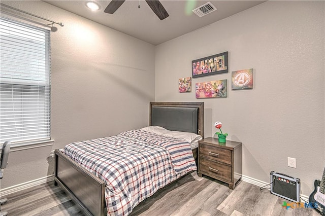 7808 Mcculloch Rd, Temple, TX 76502 - bedroom with wood finished floors, baseboards, a textured wall, and a ceiling fan