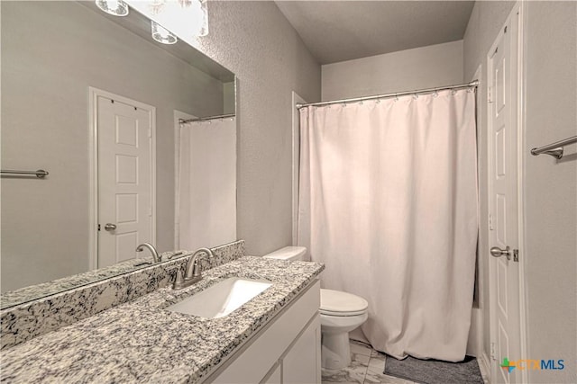 7808 Mcculloch Rd, Temple, TX 76502 - bathroom featuring marble finish flooring, toilet, vanity, a textured wall, and a shower with shower curtain