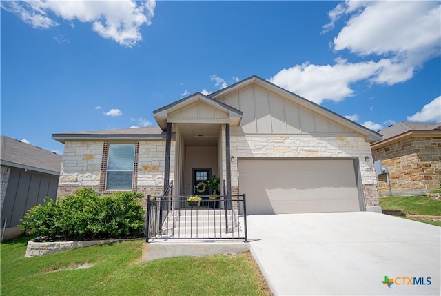 7808 Mcculloch Rd, Temple, TX 76502 - view of front of house with board and batten siding, stone siding, an attached garage, and concrete driveway